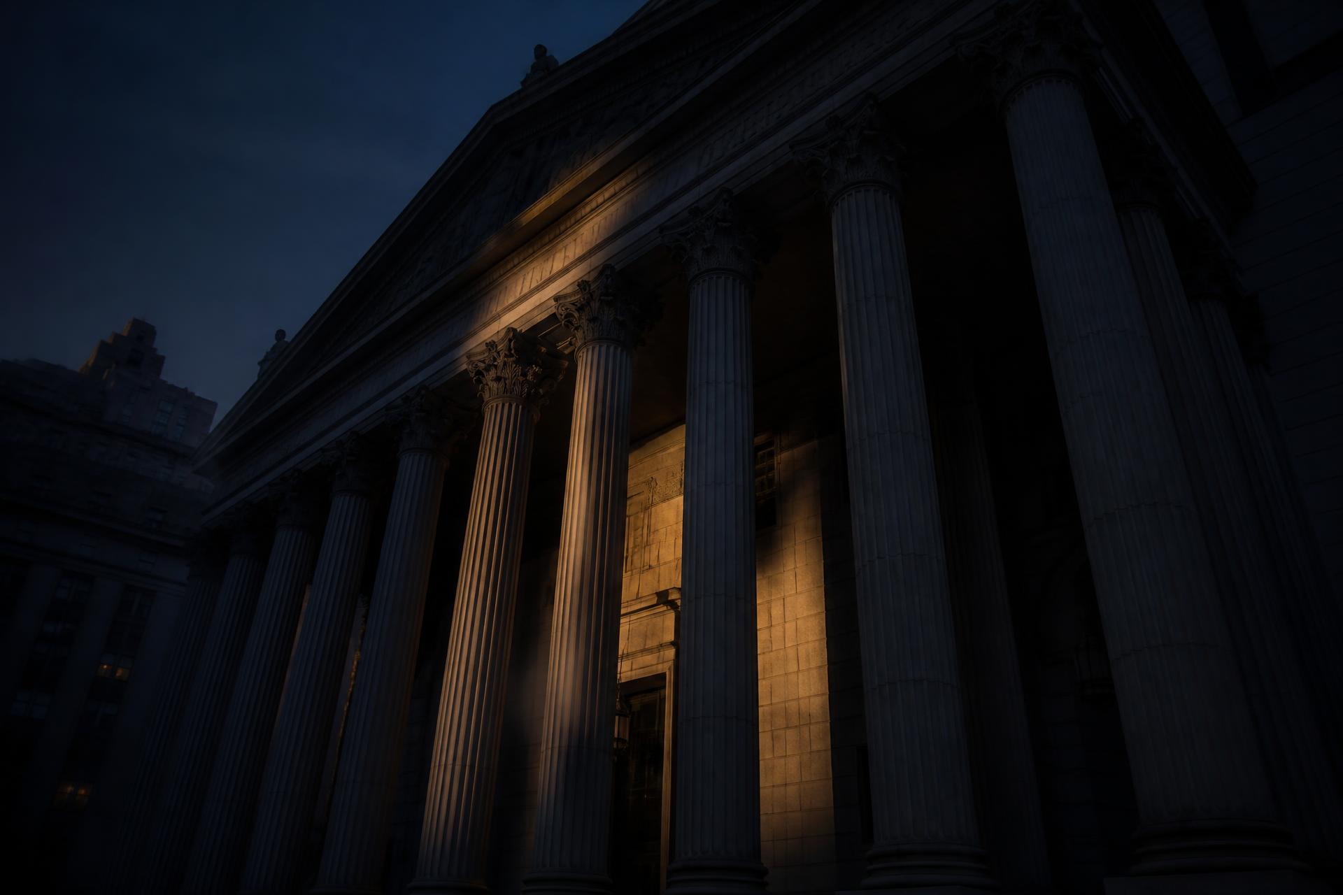 Columns of a New York courthouse at dusk